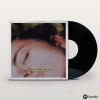 a black lp with an image of a woman with her eyes closed